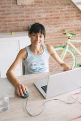 Smiling woman working at laptop at home