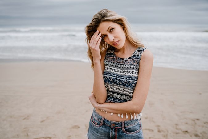 Happy female posing on sandy beach