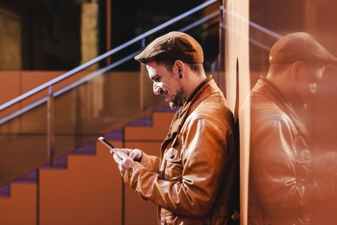 Man using mobile phone in modern building
