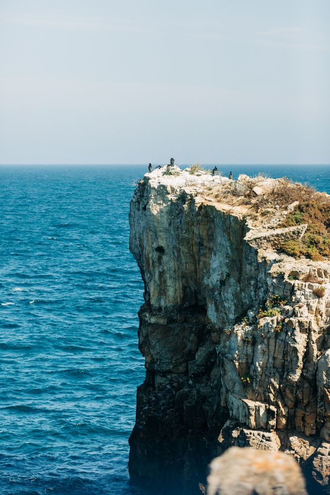 Rough cliff in blue sea