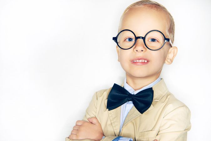 Cute blond boy in spectacles and bow tie