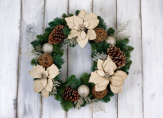Holiday Poinsettia Christmas wreath on rustic light wood