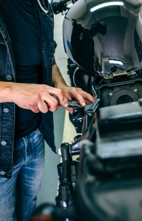 Mechanic repairing customized motorcycle