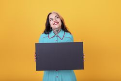 woman holding a blank sign