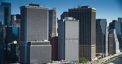 Wall Street Financial District Architecture in New York City, USA. Aerial Photo with Office Buildings and Skyscrapers on a Summer Sunny Day with Blue Sky