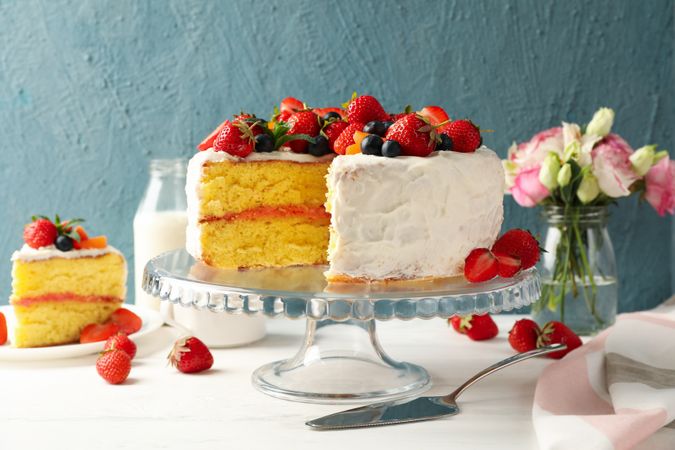 Composition with delicious berry cream cake on wooden table. Tasty dessert