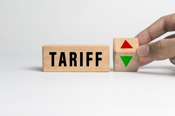 tariff words text and up and down arrow on wooden blocks