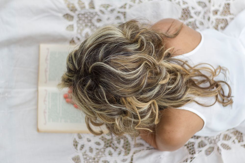 woman with book on the floor