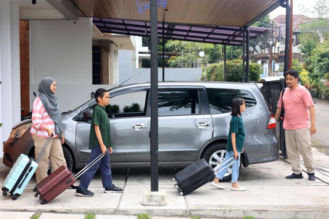 Happy Asian Muslim Family Going on Mudik Road Trip Back Home During Eid Mubarak Celebration