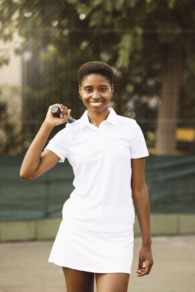 Young women with a racket in a tennis court
