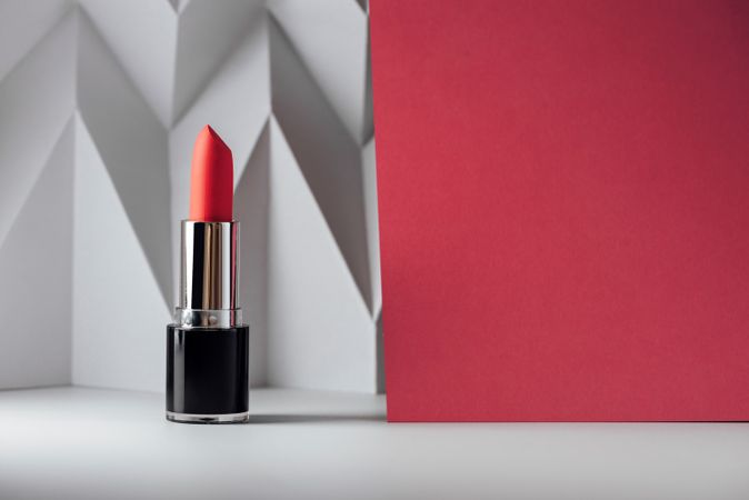 Pink lipstick on raised chevron. Product and make up contemporary concept