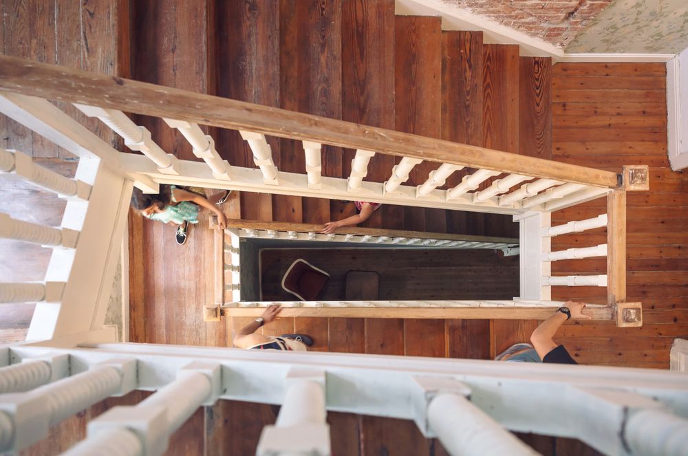 Looking down at spiral staircase as people ascend