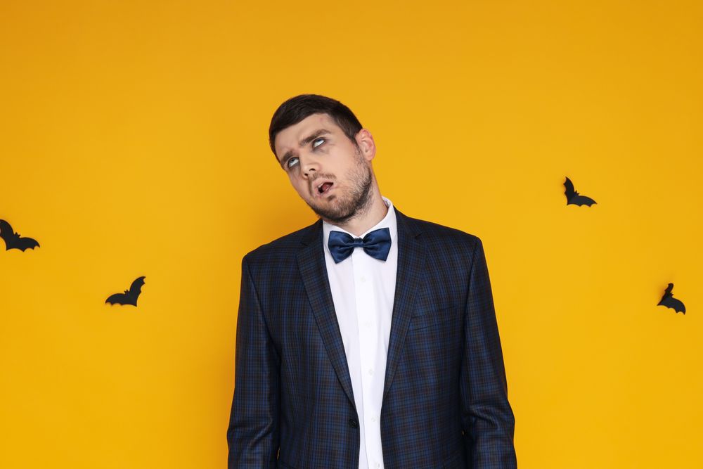 Concept of Halloween, young man on yellow background