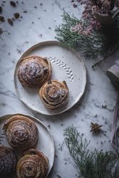 Herbs and napkin near cinnamon rolls