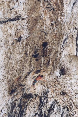 Anonymous man climbing rock