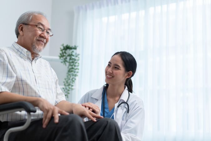 Mature male smiling with medical professional
