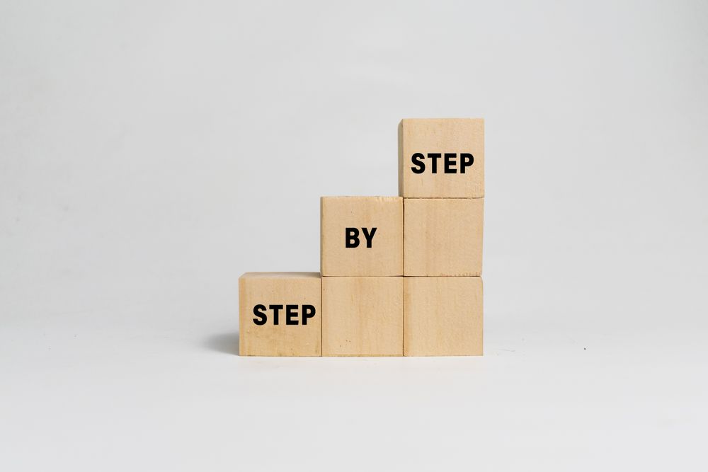 step by step word on wooden blocks staircase