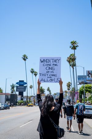 Los Angeles, CA, USA — June 14th, 2020: back view of woman holding protest sign