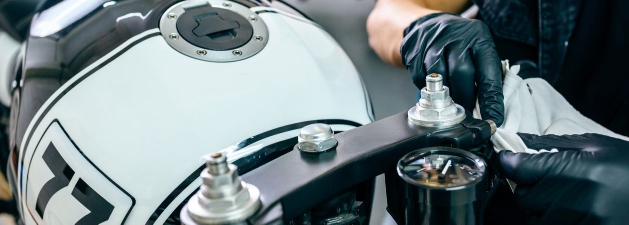 Mechanic cleaning a motorcycle