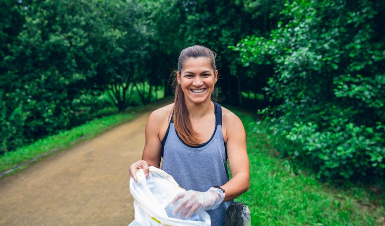 Woman with bag doing trash pick up