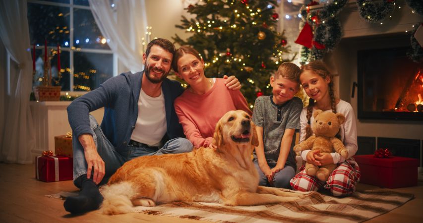 Happy Family Looking at Camera and Smiling, Hugging Each Other.