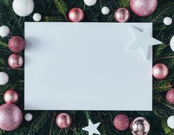 Pine tree branches with pink baubles, star decorations and paper center
