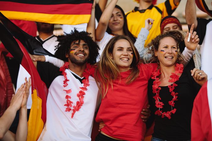 German football team supporters enjoying during a live match at stadium