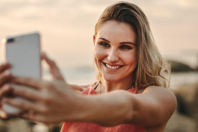 Woman taking selfie on beach