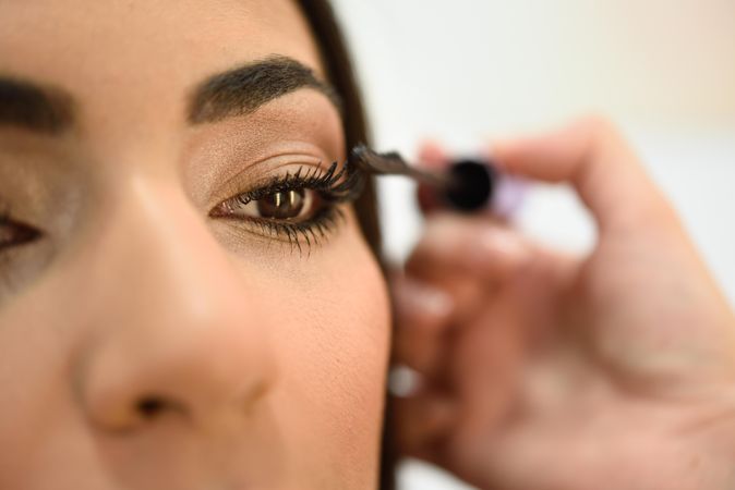 Woman applying product to client’s eyelashes