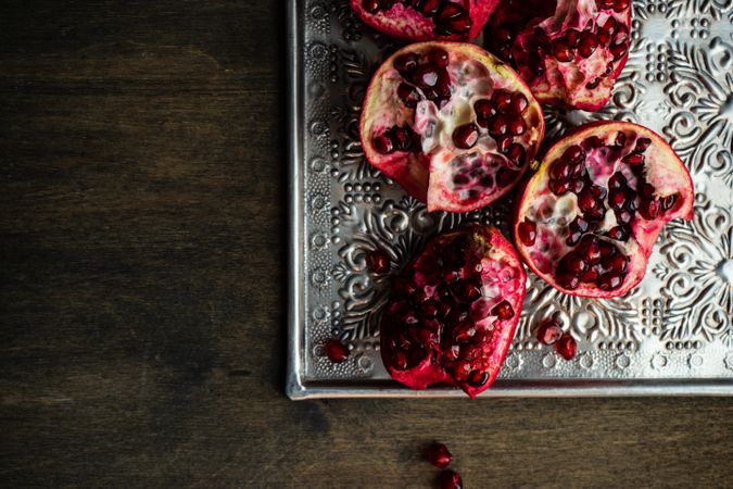 Open pomegranate on silver ornate tray