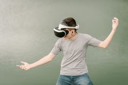 Young teenager with virtual reality glasses outdoors