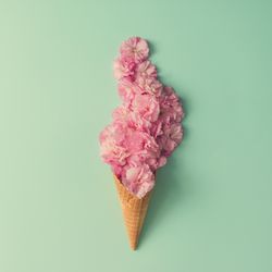 Ice cream cone with pink flowers and leaves
