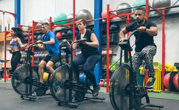 Athletes doing air bike indoor