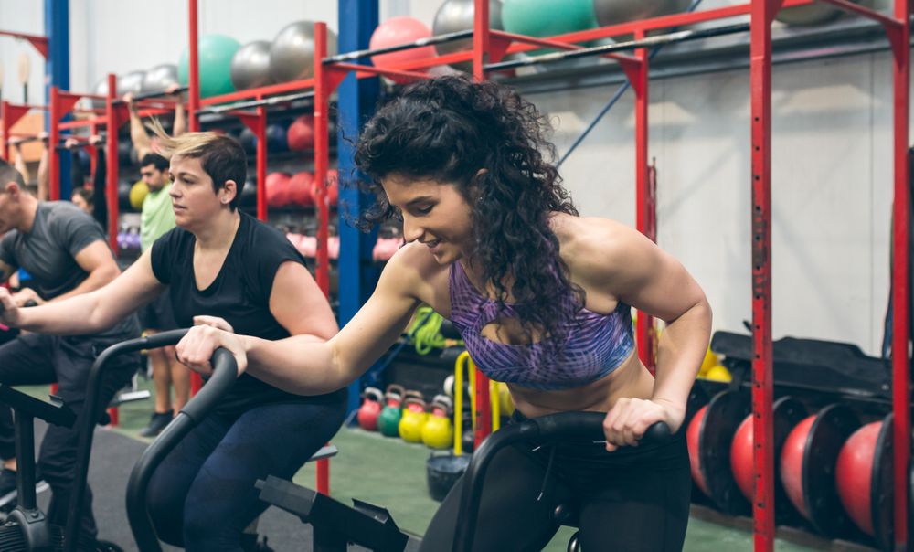 Sportswomen doing air bike indoor