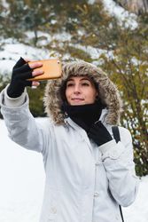 Woman taking selfie on nature at winter