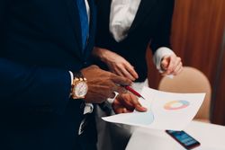 Cropped image of businessman's hand writing on paper