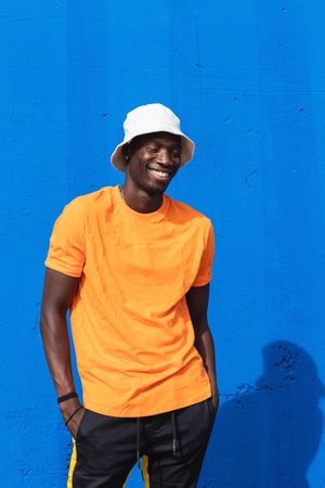 Black man in bright sporty outfit and cap