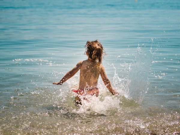 Cheerful girl having fun in warm sea
