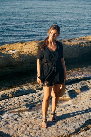 Calm woman enjoying sun on beach