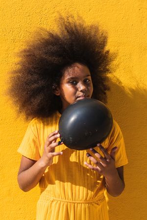 Black girl holding party balloon