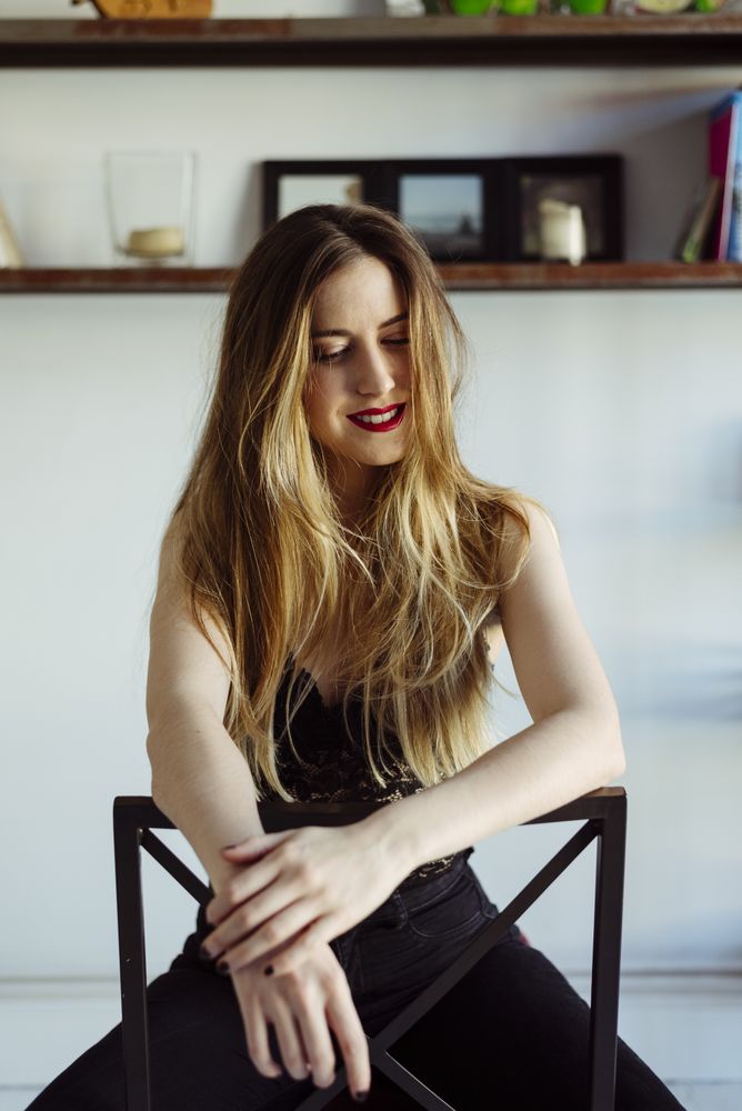 woman in bra sitting on chair