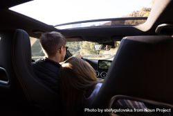 Woman leaning on boyfriend as he drives vehicle 5ka8Lb