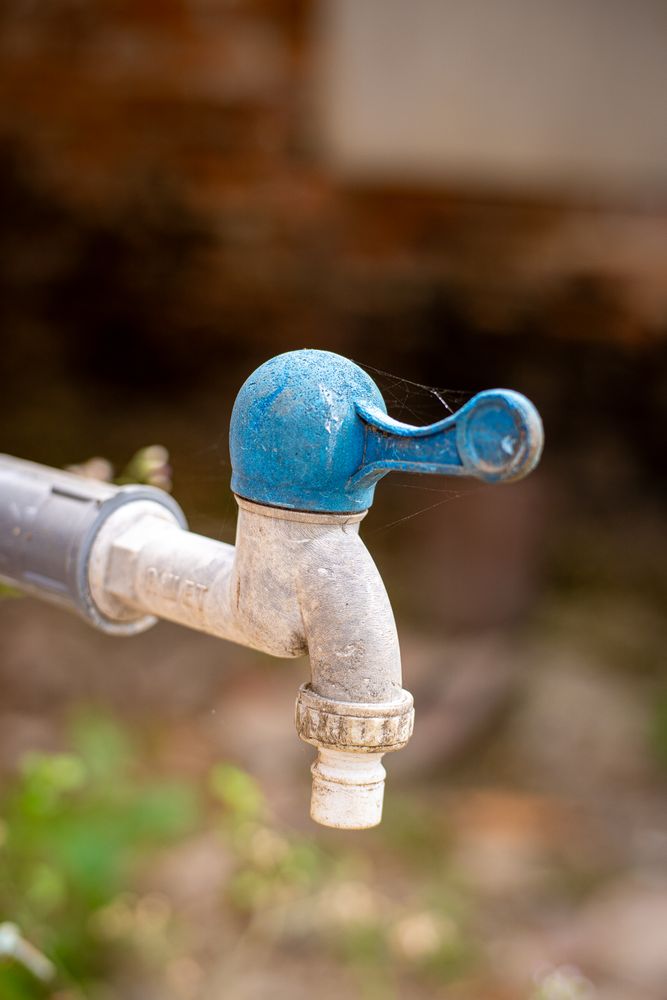 A faucet with a blue cap on it
