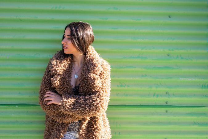 Stylish female near green wall
