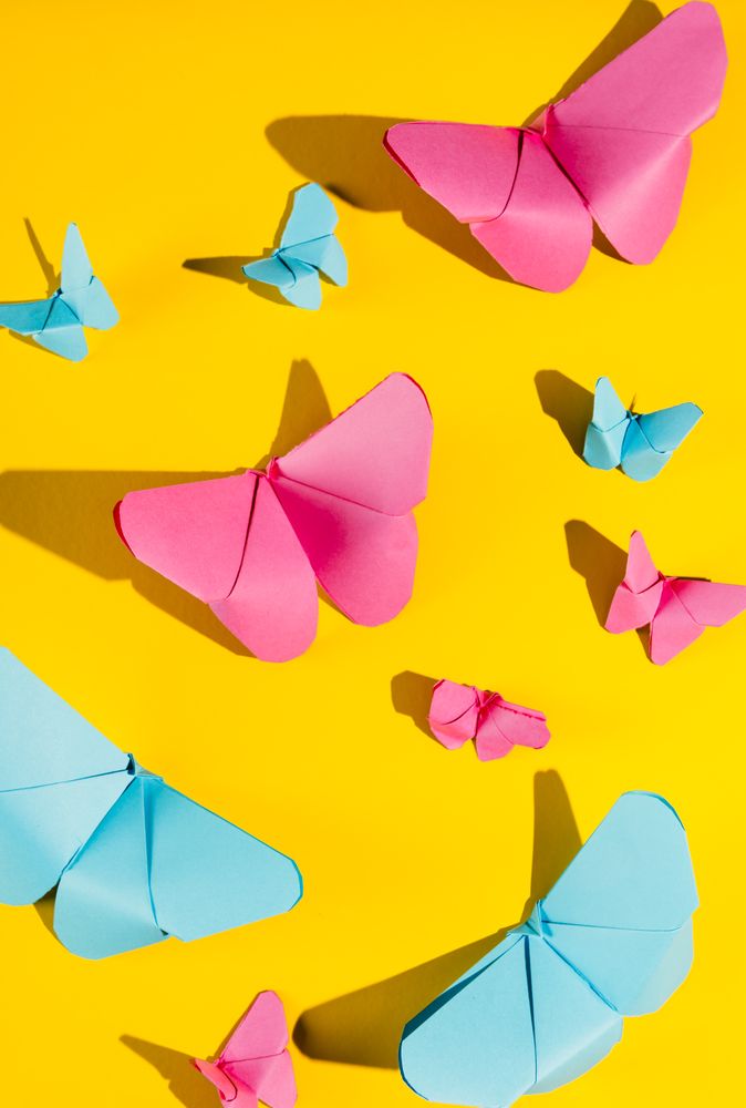 Paper butterflies on yellow cardboard