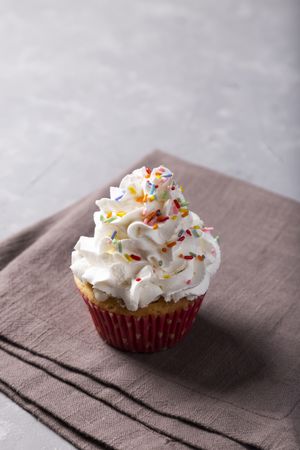 Tasty party cupcakes on the table. Cupcakes with whipped cream.