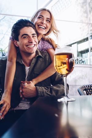 Happy young couple drinking beverages outdoors