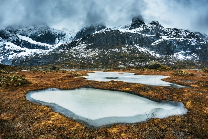 Water lakes under snow covered mountain