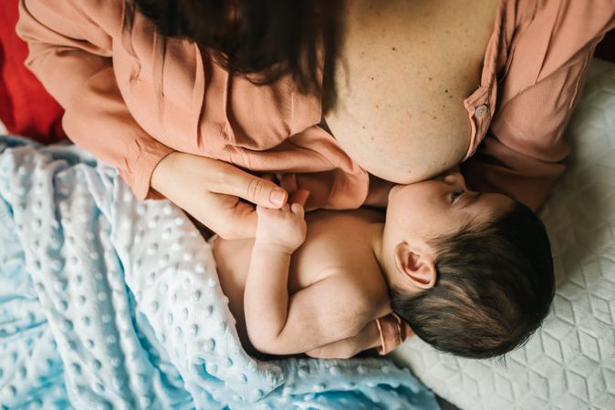 Mom breastfeeding at home
