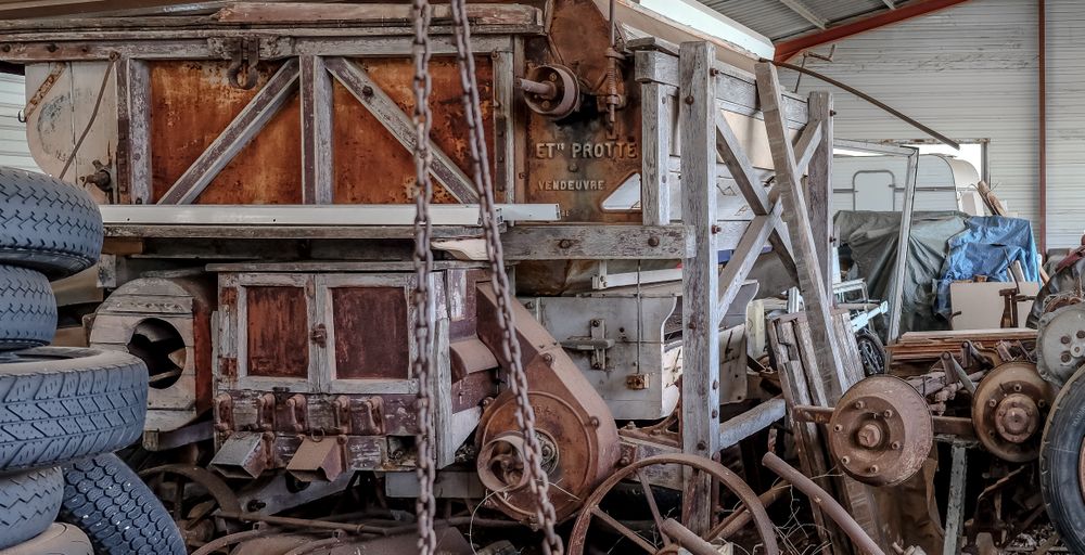 Vintage harvester farm equipment in shack